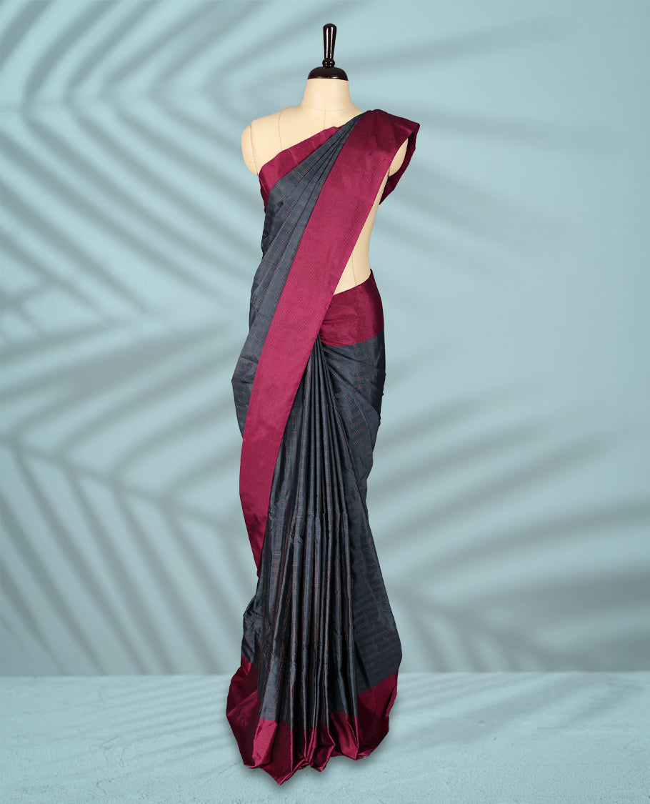 Deep Grey Colour semi silk saree features a fine checked body design, complemented by a rich Wine border, and comes with a matching blouse.