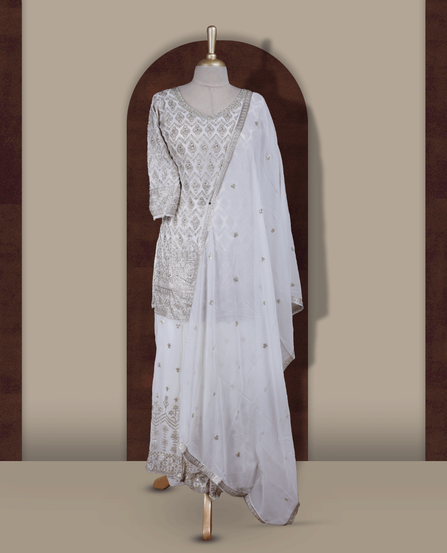 Elegant Off white colour embroidered sharara set featuring intricate copper toned thread work and delicate stones & sequin detailing, paired with a graceful off white dupatta adorned with subtle motifs and a beautifully flared embroidered bottom.