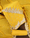 Yellow colour churidhar material adorned with elegant golden floral embroidery and delicate motifs, paired with a matching embroidered dupatta and plain bottom.