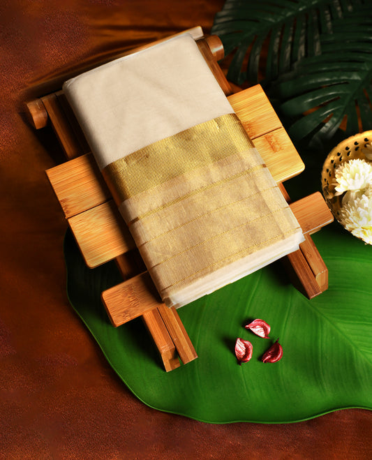 Off white pure handloom cotton double dhoti featuring a grand golden zari kara with rich woven detailing, crafted to reflect traditional splendour, making it perfect for weddings, festivals, and auspicious occasions.
