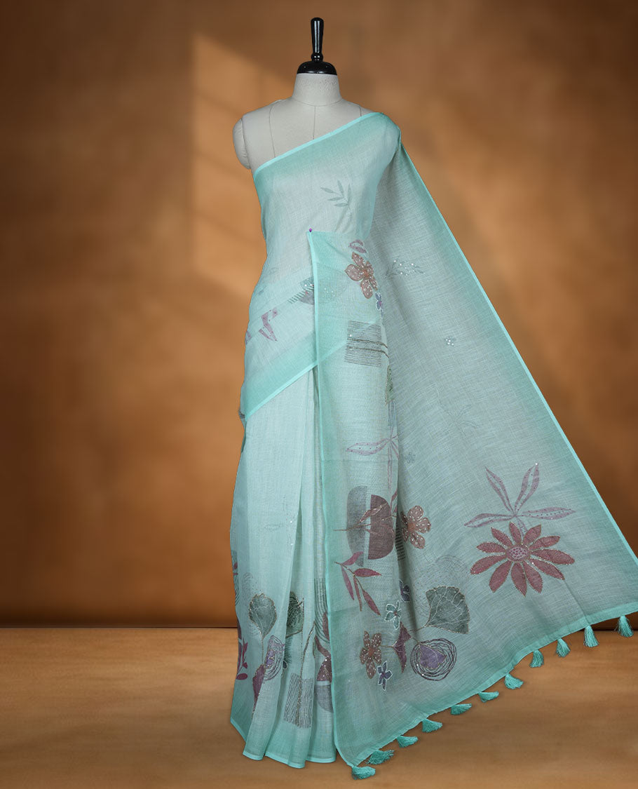 Light Blue colour Linen saree featuring Blue colour fade border with floral beats pattern around floral print across body without border, pallu and matching blouse piece.