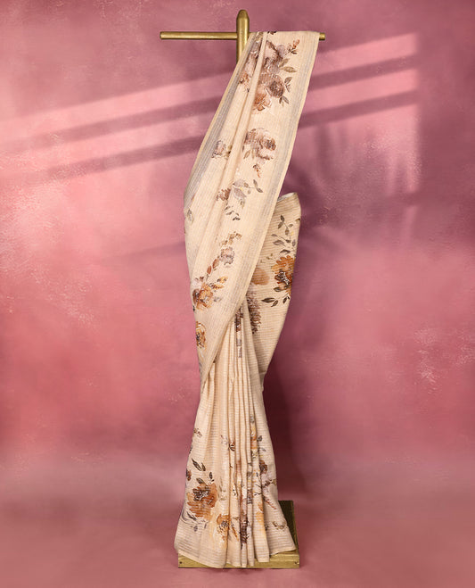 Cream colour pure linen saree featuring elegant floral prints in earthy tones all over the body, finished with a minimal border and comes with a matching blouse