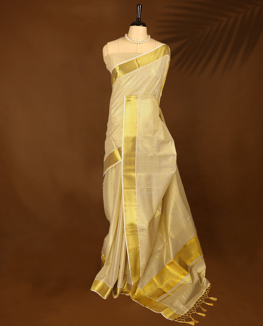 Kerala tissue saree features intricate golden zari work woven into delicate stripes and bold borders with Matching Blouse