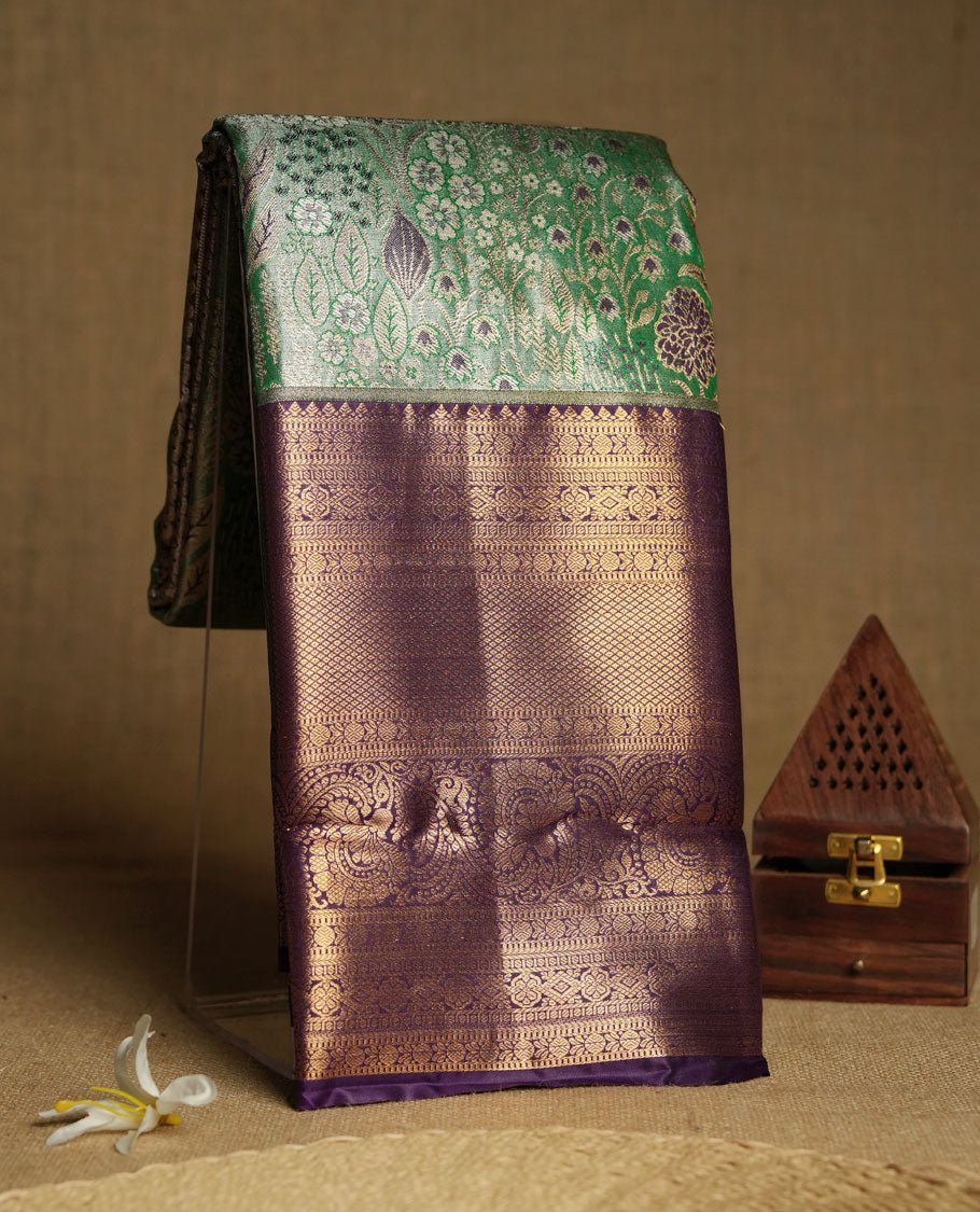Aqua green colour and Antique gold Zari Tissue Brocade Saree features intricate floral Motifs on body and rich violet colour border & pallu with traditional patterns paired with matching blouse