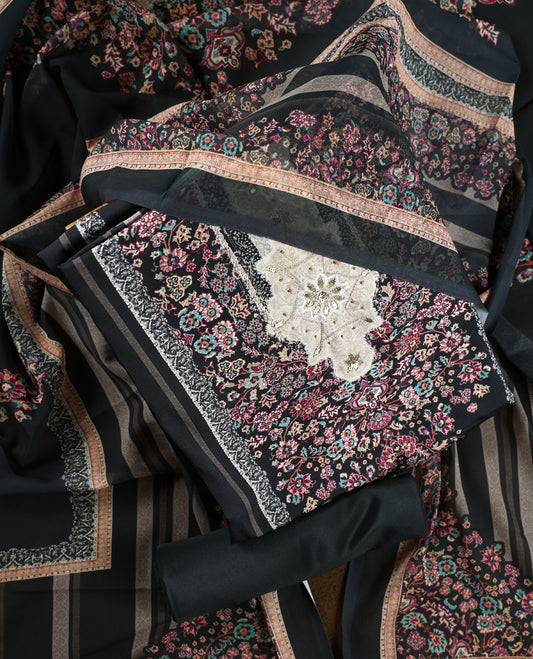 Black colour churidhar set featuring floral prints in pink, teal & beige, paired with plain black bottom and matching dupatta adorned with elegant embroidery.