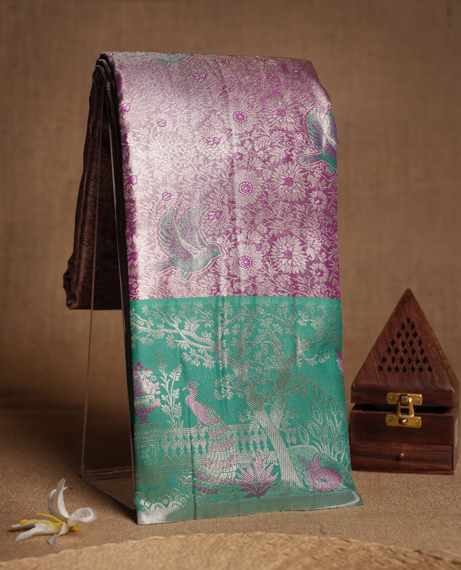 Pastel purple colour and Antique gold check Zari Tissue Brocade Saree features intricate bird Motifs on body and green colour fancy border & pallu with forest patterns, paired with matching blouse