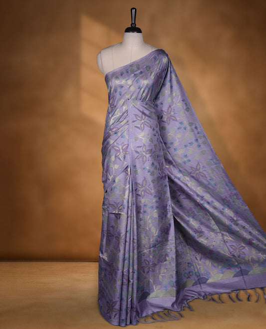Lavender colour semi jamdani tussar saree featuring woven Floral kodi & butterfly motifs on the body, complemented by a self colour without border pallu, paired with a matching blouse.