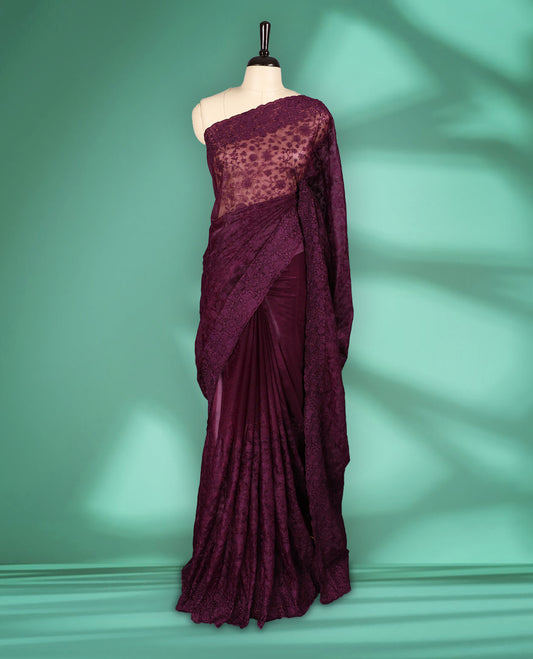 Deep Violet colour organza fancy saree adorned with intricate all over embroidery work in floral kodi patterns, finished with a matching floral embroidered border, with matching blouse