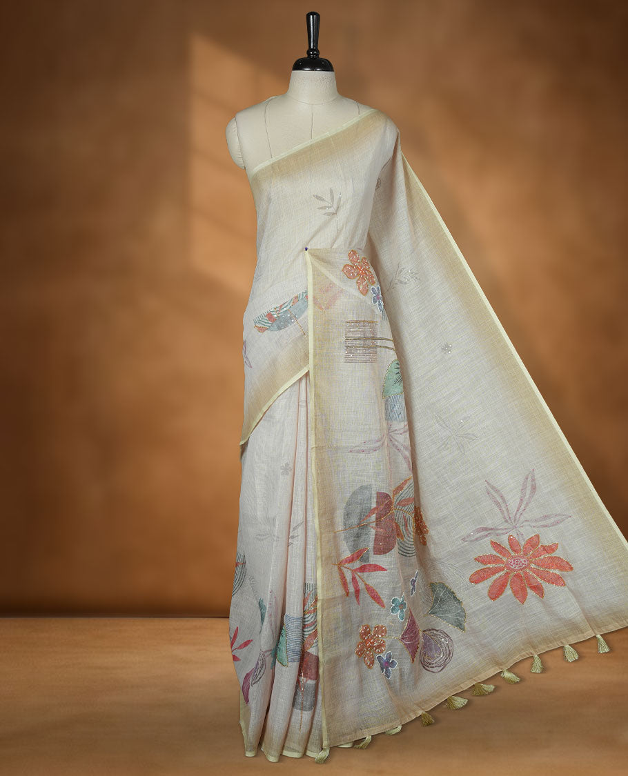 Cream colour linen silk saree featuring Light green colour fade border with floral beats pattern around floral print across body without border, pallu and matching blouse piece.