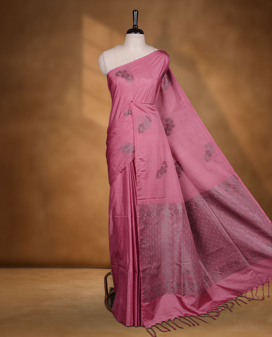 Pink colour semi soft silk saree adorned with delicate woven floral motifs on the body, complemented by a Self colour woven pallu with intricate detailing and tassel accents without border & Comes with a matching blouse piece.