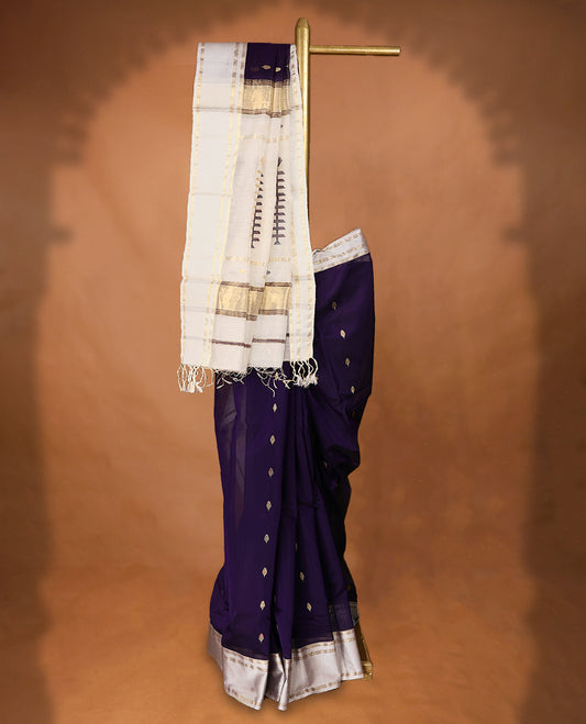 Purple coloured Maheshwari Cotton saree featuring  Antique Zari Leaf motifs across the entire body, complemented by a traditional White coloured border and a matching blouse.