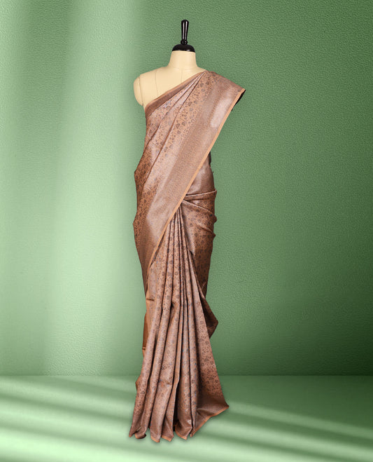 Light Pastel peach colour semi silk saree featuring neem zari floral kodi motifs all over the body, complemented by a rich self colour woven border, with matching blouse.