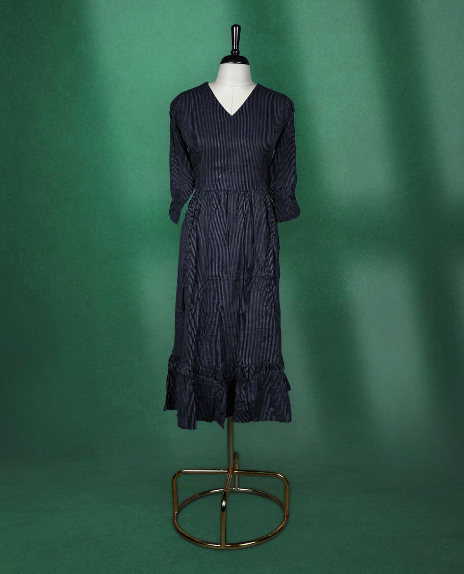 Black colour dress featuring subtle pinstripes, a V neckline, and three quarter sleeves, finished with a gathered waist and ruffled hem, chic and comfortable choice for casual outings.
