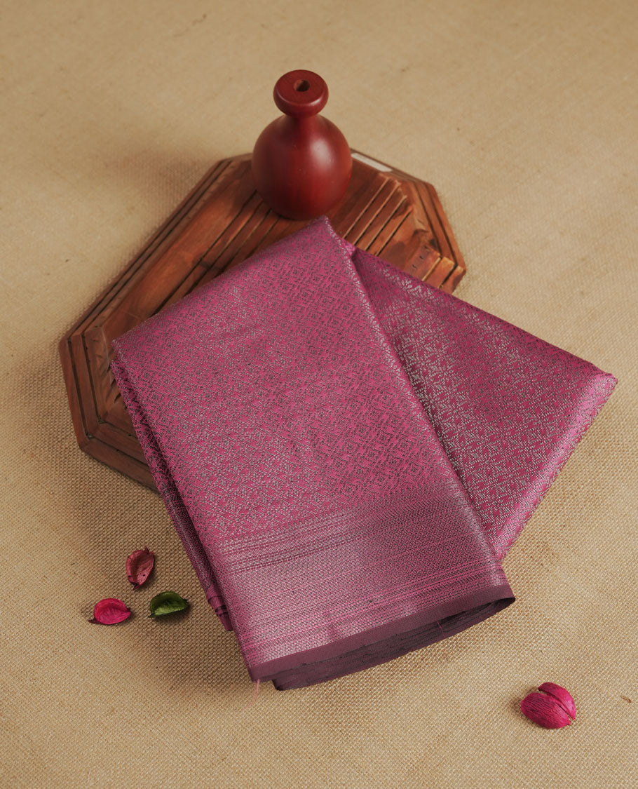 Magenta purple colour semi silk saree featuring neem zari Brocade geometric Pattern all over the body, complemented by a Self Colour woven border with detailing, Pallu & blouse.
