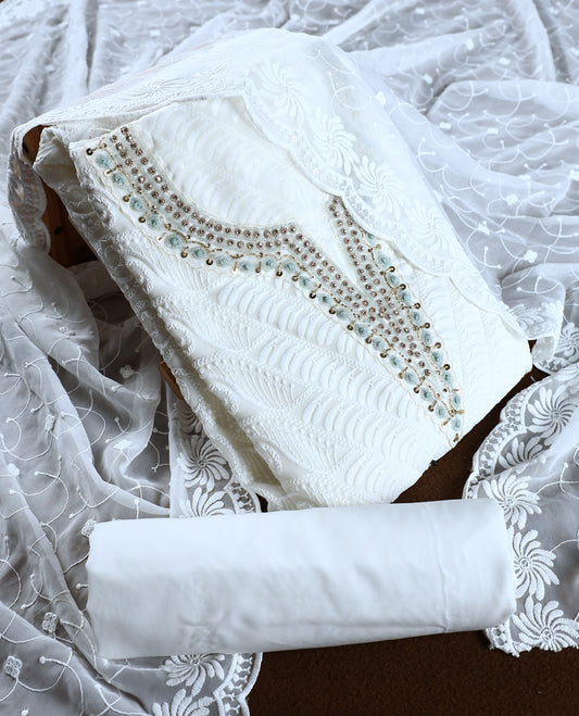 White colour churidhar material featuring delicate embroidery with blue colour sequins and bead highlights, paired with a plain white bottom & Comes with a matching embroidered net dupatta.