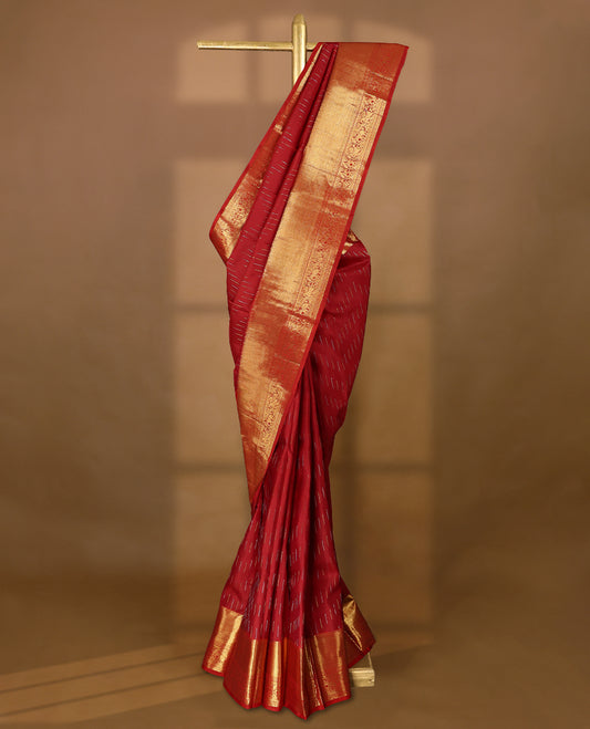 Deep red Colour pure traditional Kancheepuram silk saree adorned with intricately woven antique zari work on the body, complemented by Self colour traditional border featuring elephant, Horse, and Floral Kodi motifs, and paired with a matching blouse.