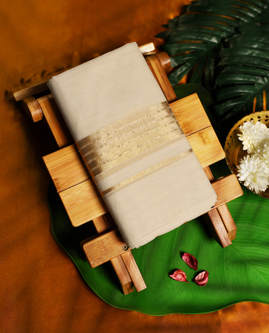 Beige pure handloom cotton double dhoti with a broad golden zari border featuring intricate woven patterns, offering breathable comfort and timeless elegance, perfect for weddings, rituals, and festive wear.