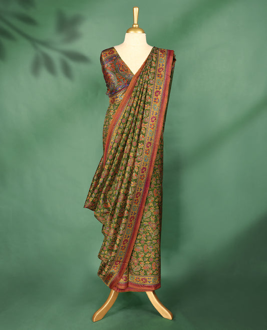 Grass green Colour Manipuri saree showcases a body with vibrant paisley and floral motifs, accentuated by a multicolour traditional printed border in golden yellow and maroon, and comes with a matching blouse.