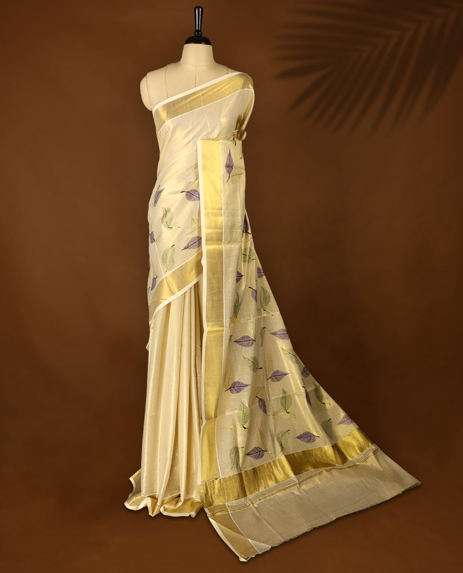 Light Gold colour Tissue Kerala saree featuring Leaves thread work on body and a beautifully woven Gold Kasavu border, paired with a matching blouse perfect for festive occasions.