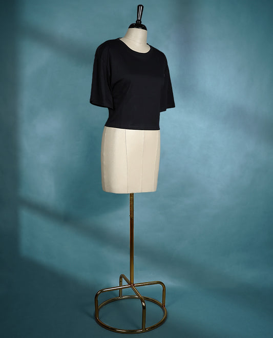Black oversized T shirt featuring a round neck and dropped shoulders, crafted from soft cotton for a relaxed and modern silhouette.