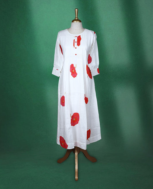 White colour A line kurti featuring a round neck with front pleated detailing, three quarter sleeves, and bold red floral prints for a fresh and elegant look.