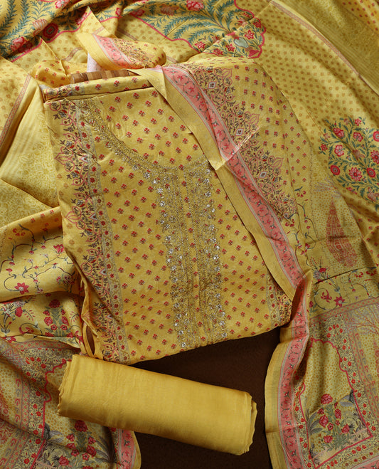 Yellow colour churidhar material with delicate floral embroidery on the neckline, complemented by a vibrant printed dupatta and plain bottom.