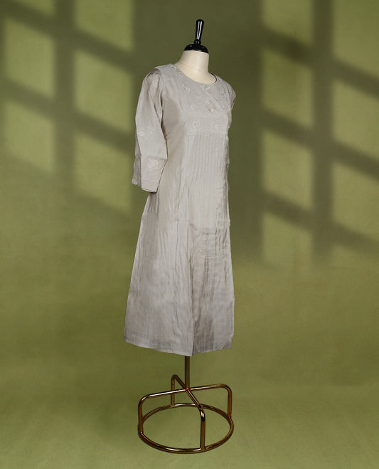 Beige colour straight fit kurti featuring a round neck, 3/4th sleeves, and delicate floral embroidery on the bodice and sleeves