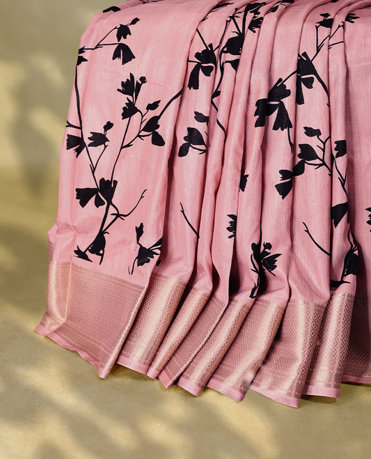 Pastel pink colour semi printed saree featuring black florak kodi prints across the body, finished with a Golden Zari border, with matching blouse