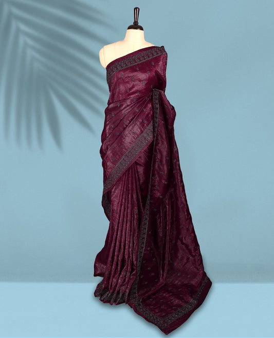 Maroon Colour crush soft silk saree, textured body with a natural crinkled finish, adorned with intricate Silver colored floral Motifs and complemented by a delicate Silver Zari embroidery border, paired with a matching blouse