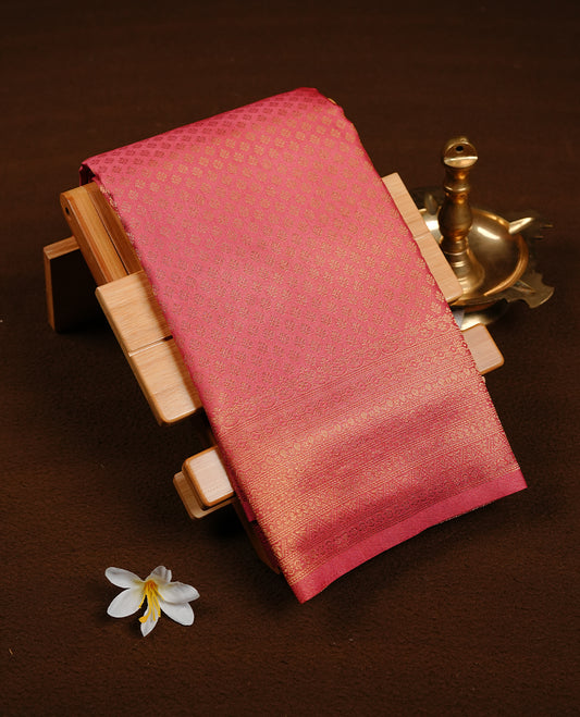 Mauve colour soft silk saree featuring gold zari pattern on body, complemented by self colour with traditional border, paired with matching blouse piece.