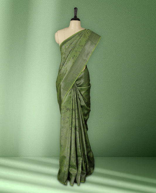 Light green colour semi silk saree featuring neem zari floral kodi motifs all over the body, complemented by a rich self colour woven border, with matching blouse.