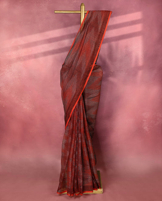 Red and black colour pure linen saree featuring subtle ikkat style patterns all over the body, paired with a simple red border and comes with a matching blouse