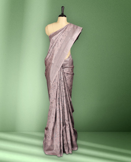Light Pastel Pink colour semi silk saree featuring neem zari floral kodi motifs all over the body, complemented by a rich self colour woven border, with matching blouse.