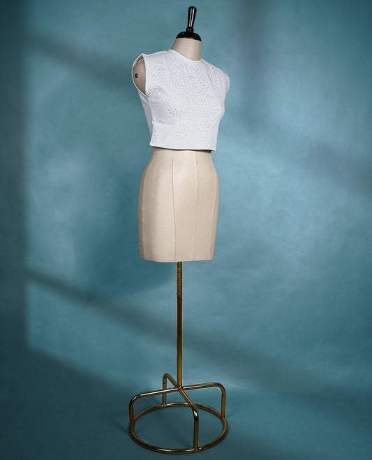 White sleeveless crop top featuring a round neck and all over small stone dot pattern for a chic, minimal look.