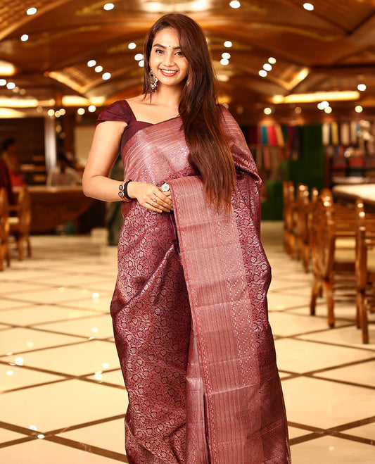 Maroon colour pure Kancheepuram brocade saree featuring an allover antique zari floral brocade on the body, complemented by a rich brocade border and a grand, heavily zari-woven pallu, paired with a matching brocade blouse