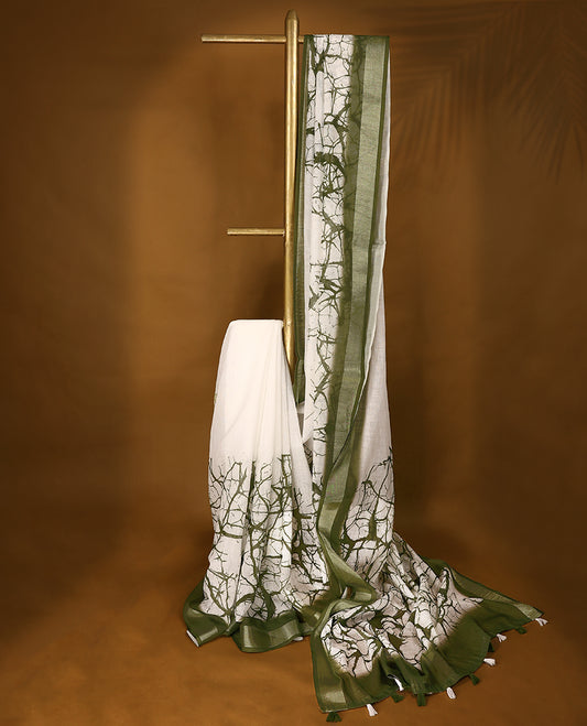 White cotton saree adorned with green abstract patterns and a rich green border with Matching Blouse