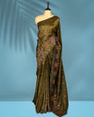 Olive Colour crush soft silk saree, textured body with a natural crinkled finish, adorned with intricate Multi colored floral Motifs and complemented by a delicate Multi Colour Bold Floral embroidery border, paired with a matching blouse