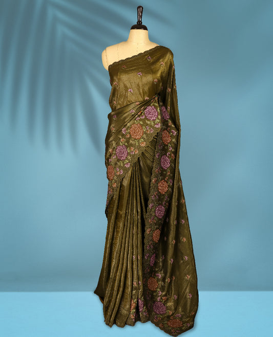Olive Colour crush soft silk saree, textured body with a natural crinkled finish, adorned with intricate Multi colored floral Motifs and complemented by a delicate Multi Colour Bold Floral embroidery border, paired with a matching blouse
