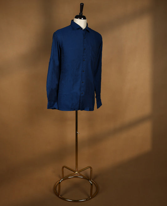Deep blue colour Peter Eglend men’s shirt in a relaxed formal fit, featuring a smooth plain finish with full sleeves, classic collar, and chest pocket ideal for office and semi formal occasions.