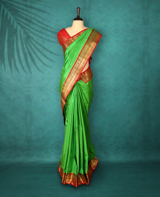 Light Green colour Traditional Kancheepuram Silk saree with small gold motifs on body, Rich Red traditional border with intricate gold zari weaving, grand zari pallu, perfect for Bharatanatyam, with matching blouse.