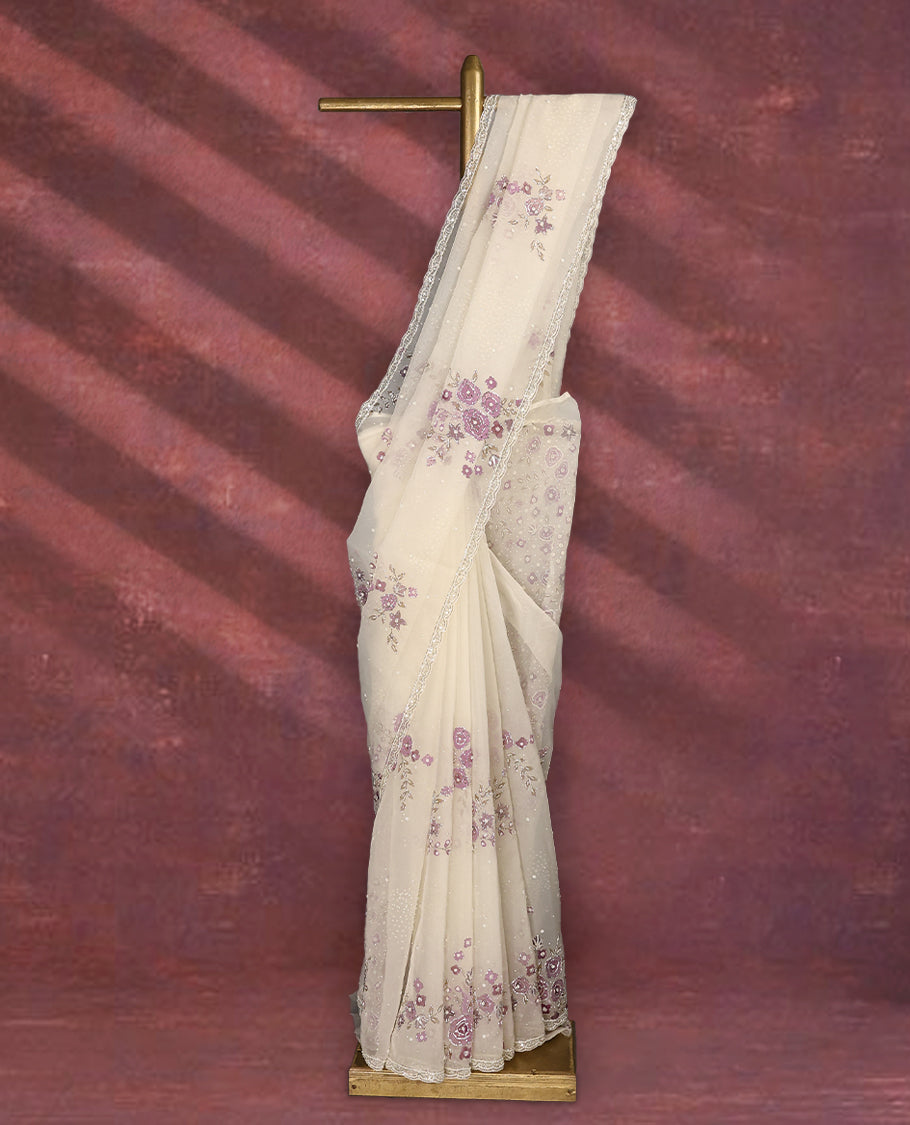 White colour pure organza saree featuring Light Purple floral prints with intricate bead and sequin work across the body, adorned with a matching embellished border, complemented by a worked pallu and paired with a heavily worked matching blouse.