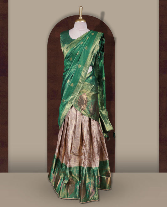 Gold and Green colour Dhavani set featuring a Gold colour skirt with contrast Green colour border with rich gold zari pattern, paired with a contrasting Green dupatta detailed with gold motifs