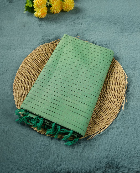 Pastel Green colour poly cotton saree with black vertical dotted line pattern on the body, paired with a matching pallu featuring black zigzag geometric border, and a coordinated all‑over black stylised fleur‑de‑lis printed blouse piece.