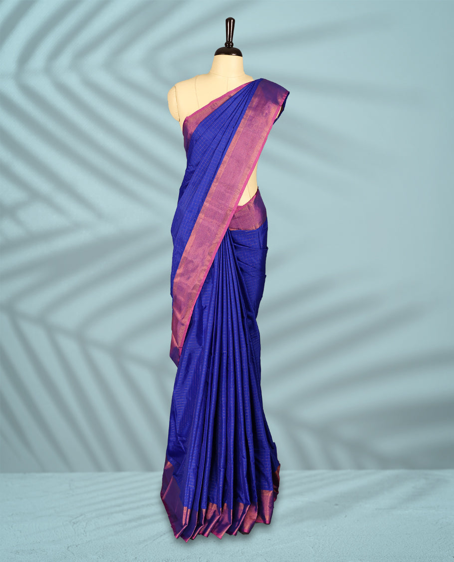 Royal blue Colour body with elegant checks, paired with a vibrant magenta pink zari border, comes with a matching blouse.