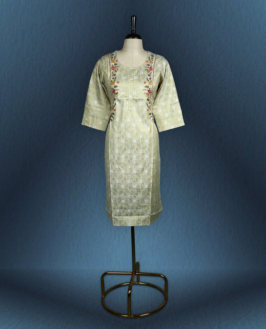 Pistachio green colour kurti with subtle floral self weave, adorned with delicate multicolour floral embroidery along the princess line, featuring a round neckline and stylish three quarter sleeves.