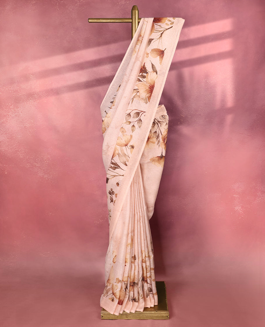Light Pastel Peach colour pure linen saree featuring elegant floral prints in earthy tones all over the body, finished with a minimal border and comes with a matching blouse