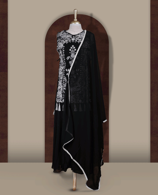 Elegant Black sharara set featuring intricate white floral embroidery,cut beads and small stone work & The outfit includes a beautifully flared bottom for graceful movement and a matching dupatta adorned with tassels for a complete festive look.