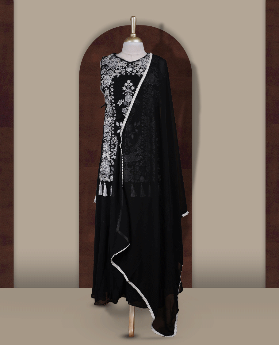 Elegant Black sharara set featuring intricate white floral embroidery,cut beads and small stone work & The outfit includes a beautifully flared bottom for graceful movement and a matching dupatta adorned with tassels for a complete festive look.