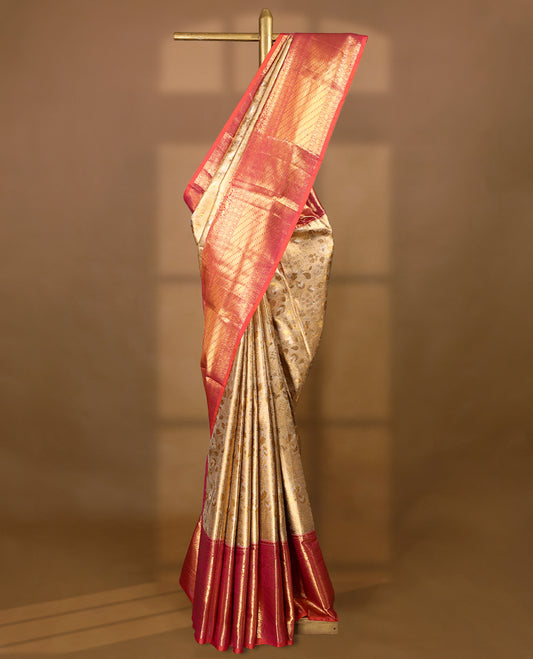 Gold colour tissue brocade saree with gold and silver zari floral kodi design on body, gold zari floral and peacock work pinkish orange border, rich matching pallu with Antique zari motifs, paired with matching blouse.