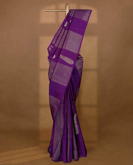 Deep royal purple Colour Kancheepuram designer saree adorned with antique zari large mango motifs, floral kodi work, and vertical gold zari lines on the body, designed without a border, and paired with a matching blouse.